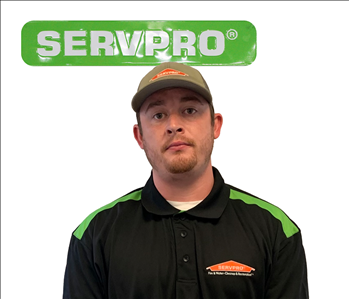 employee with SERVPRO shirt; green sign