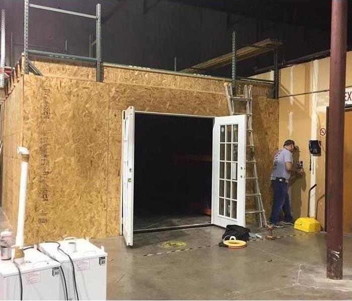a SERVPRO of Southwest Fort Worth Ozone room, white door and plywood exterior small shed-like building